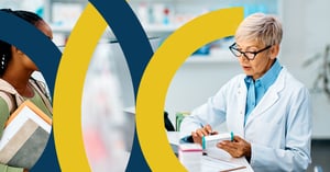 Pharmacist checking a prescription against paperwork at the pharmacy counter